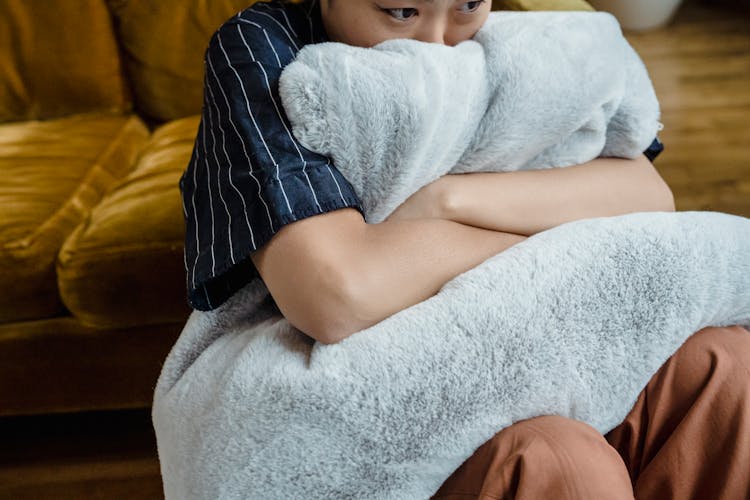 Person Hugging A Blue Fur Pillow 