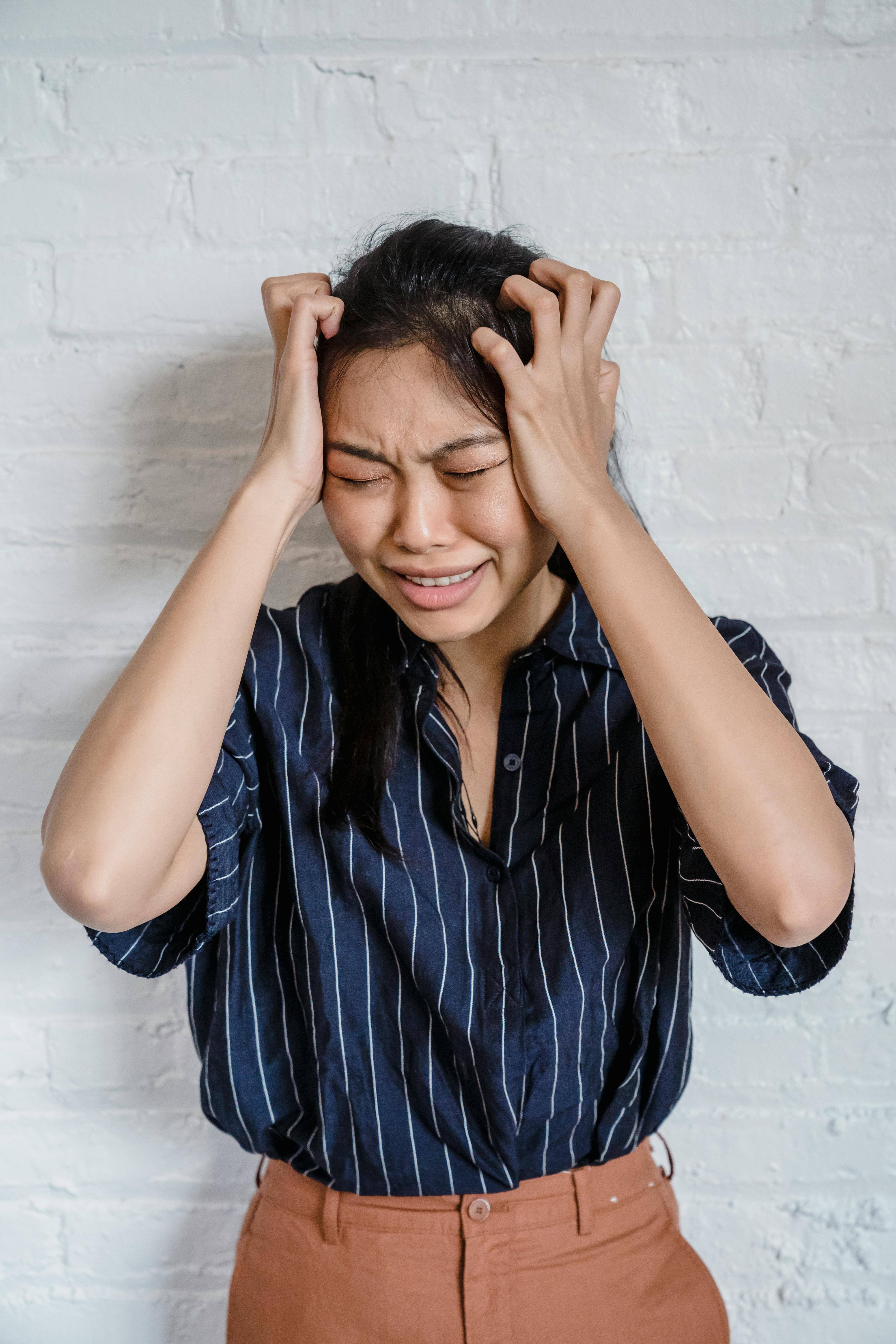 a woman holding her head