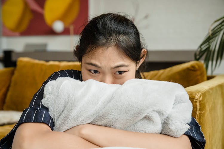 Upset Woman Hugging A Pillow 