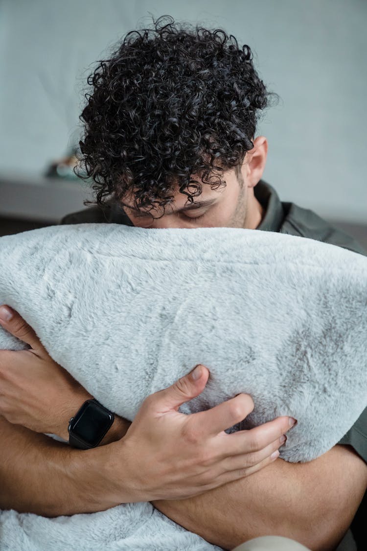 A Man Hugging His Pillow