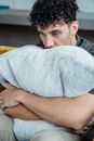 Sad Man Hugging a Blue Faux Fur Pillow