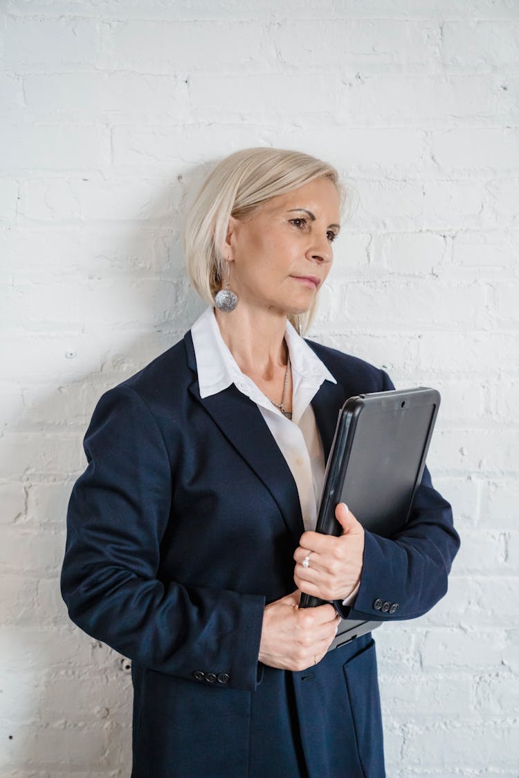 Mature Woman In Elegant Clothing Holding A Laptop