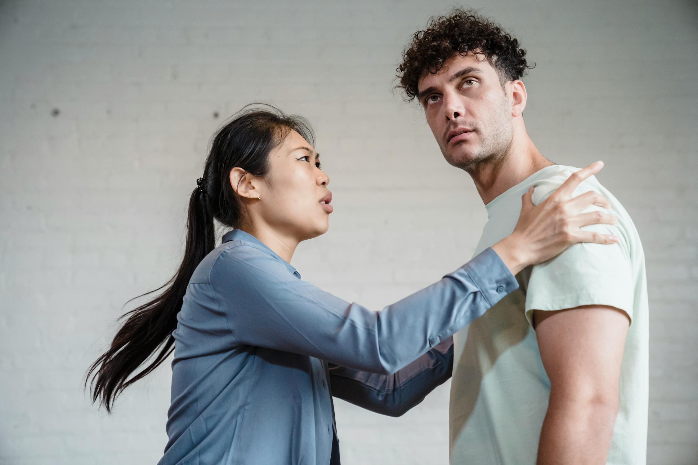 Upset Woman Holding the Man's Shoulders