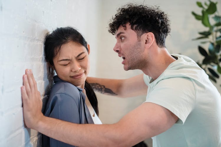 Woman Closing Her Eyes While The Man Is Screaming 