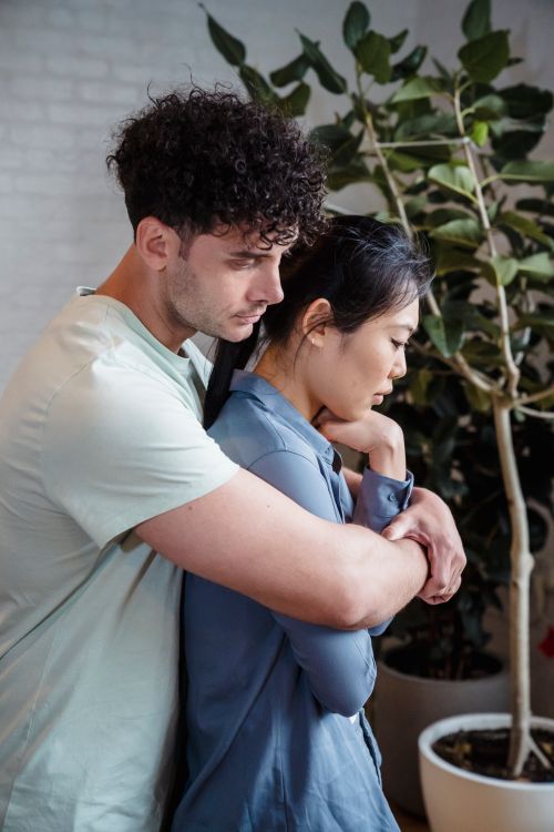 Free A couple shares a heartfelt embrace indoors, conveying emotional support. Stock Photo