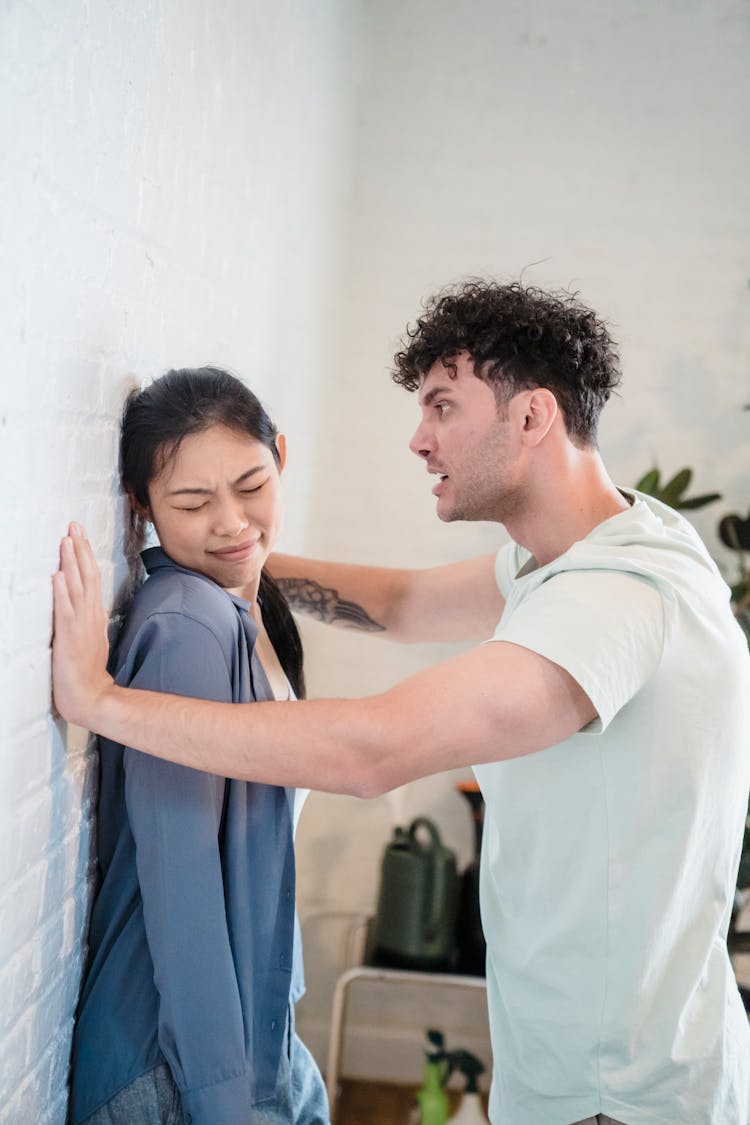 Man Shouting At Woman By Wall