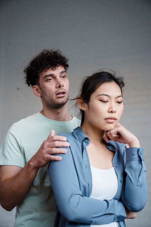 Free A couple engaged in a serious conversation, showing emotional expressions indoors. Stock Photo