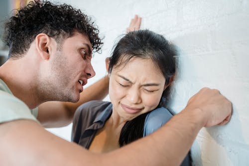 Free A Man Screaming on His Partner while Punching the Wall Stock Photo