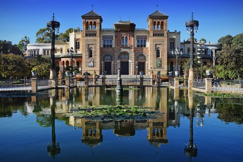 Free Stunning architecture reflecting in the pond at Maria Luisa Park, Seville, Spain. Stock Photo