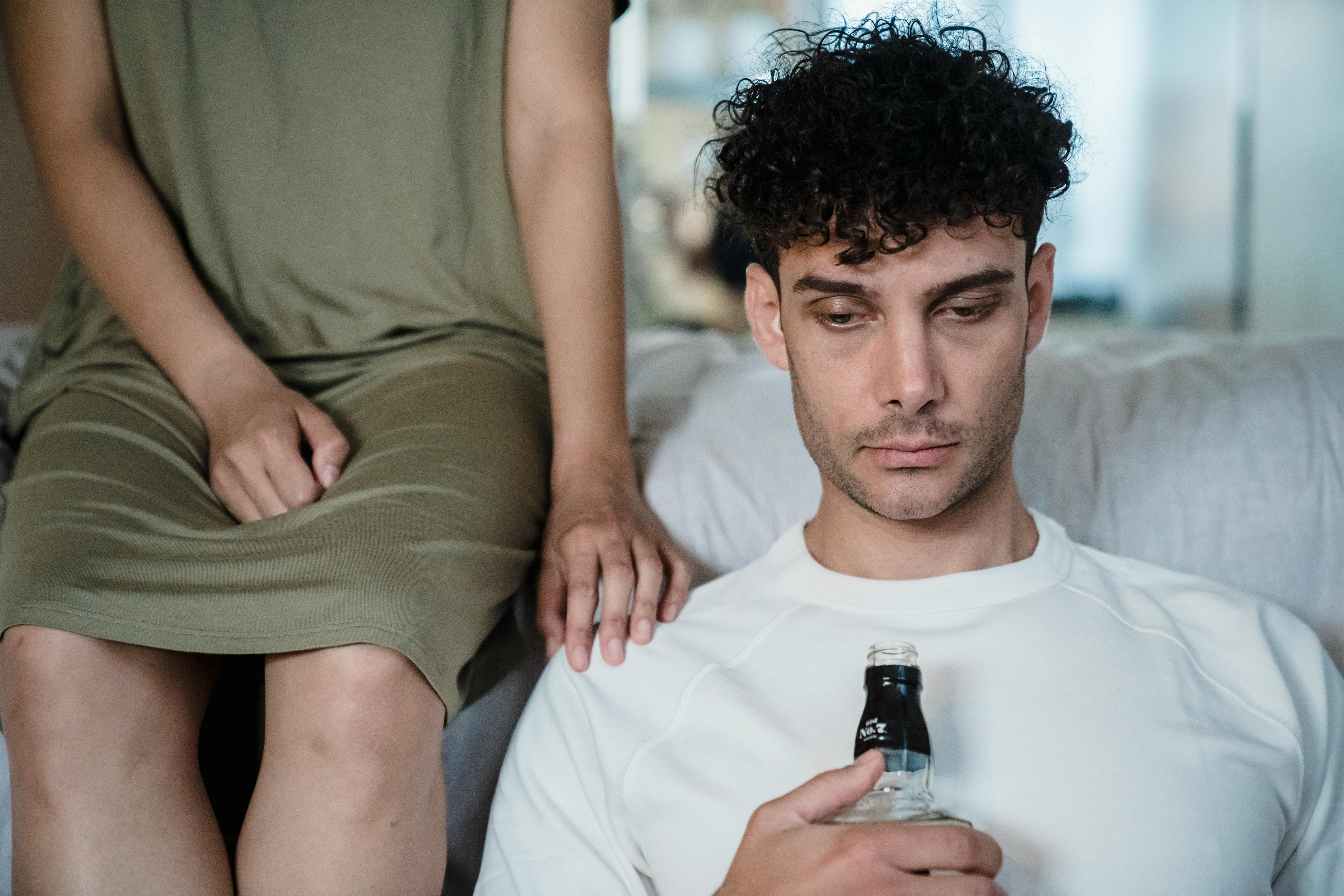 man holding a bottle of liquor