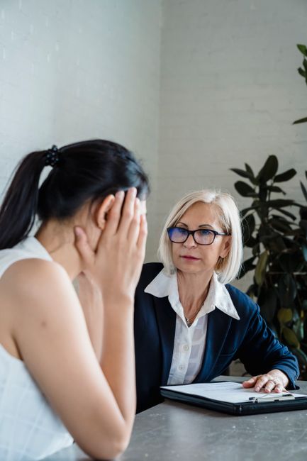 counselor talking with client desk