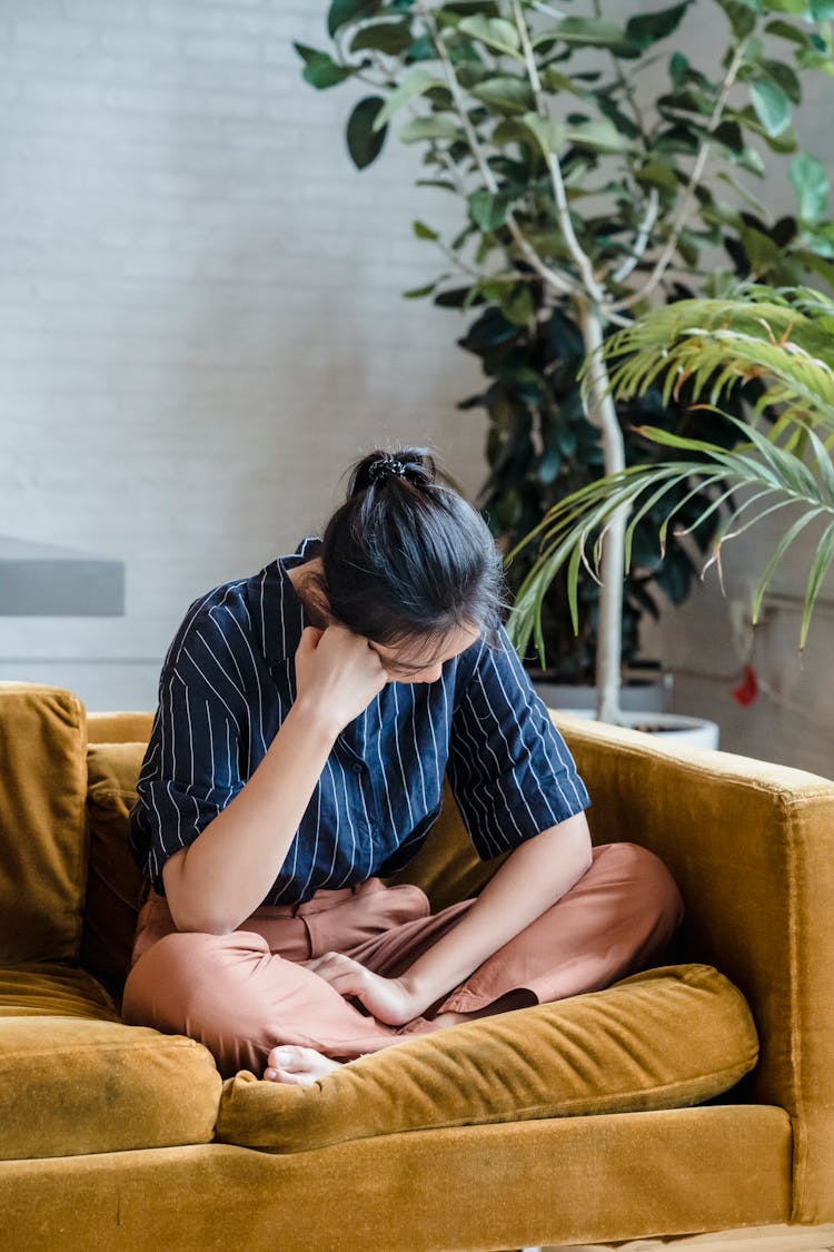 Sad Person Sitting Alone On A Couch 