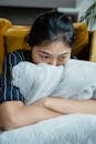 Unhappy Woman Hugging a Faux Fur Blanket