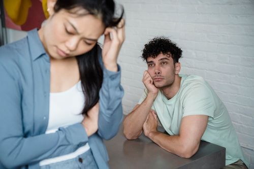 Free A man and woman deep in thought facing relationship tension, visible emotions in an indoor setting. Stock Photo