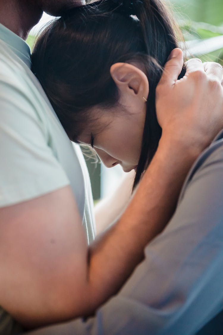 Close-up Of Woman Resting Her Head Against Her Partner Chest 