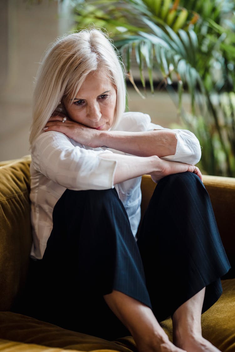 Upset Mature Woman Sitting On The Couch 