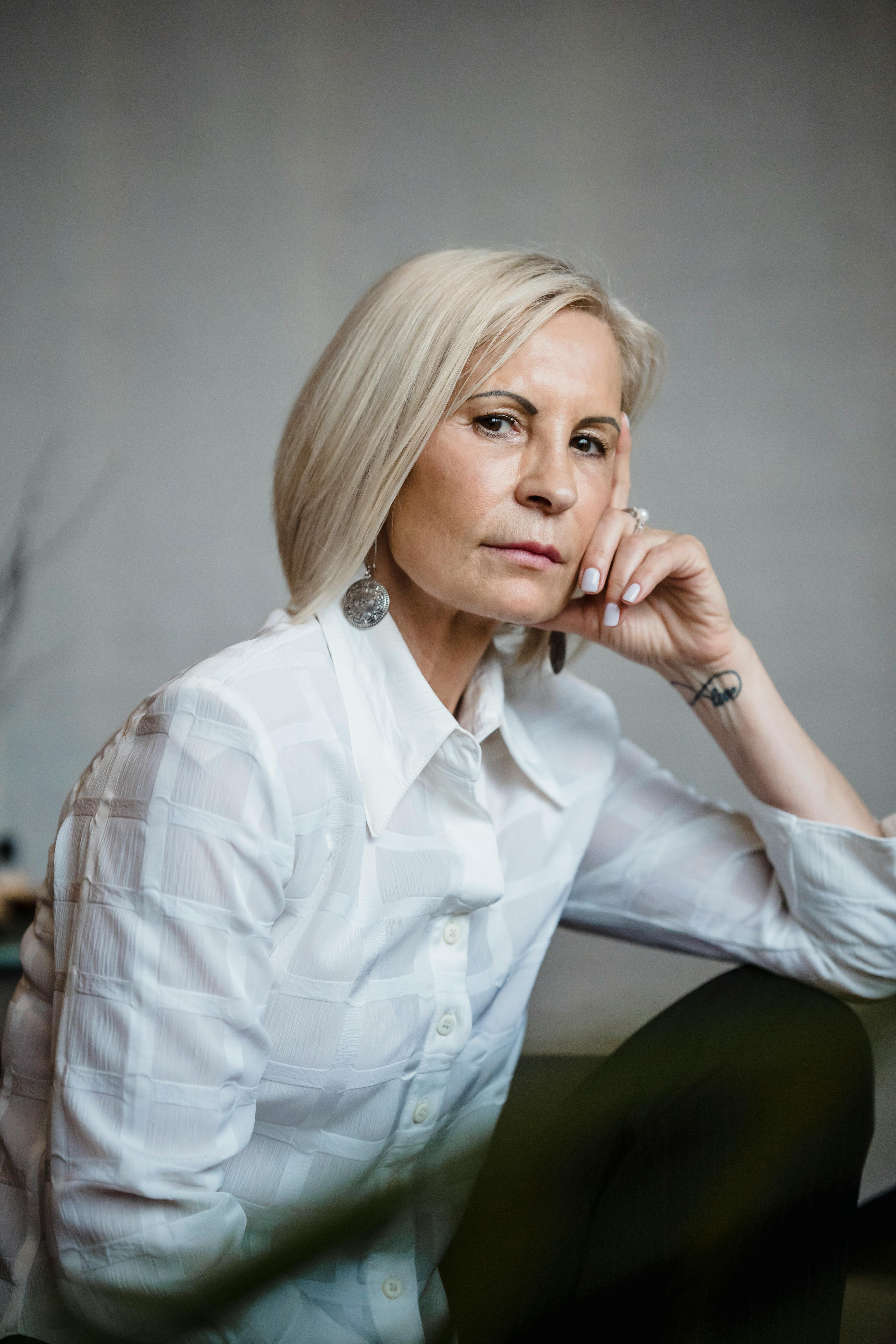 Portrait of a Mature Woman Wearing a White Shirt · Free Stock Photo