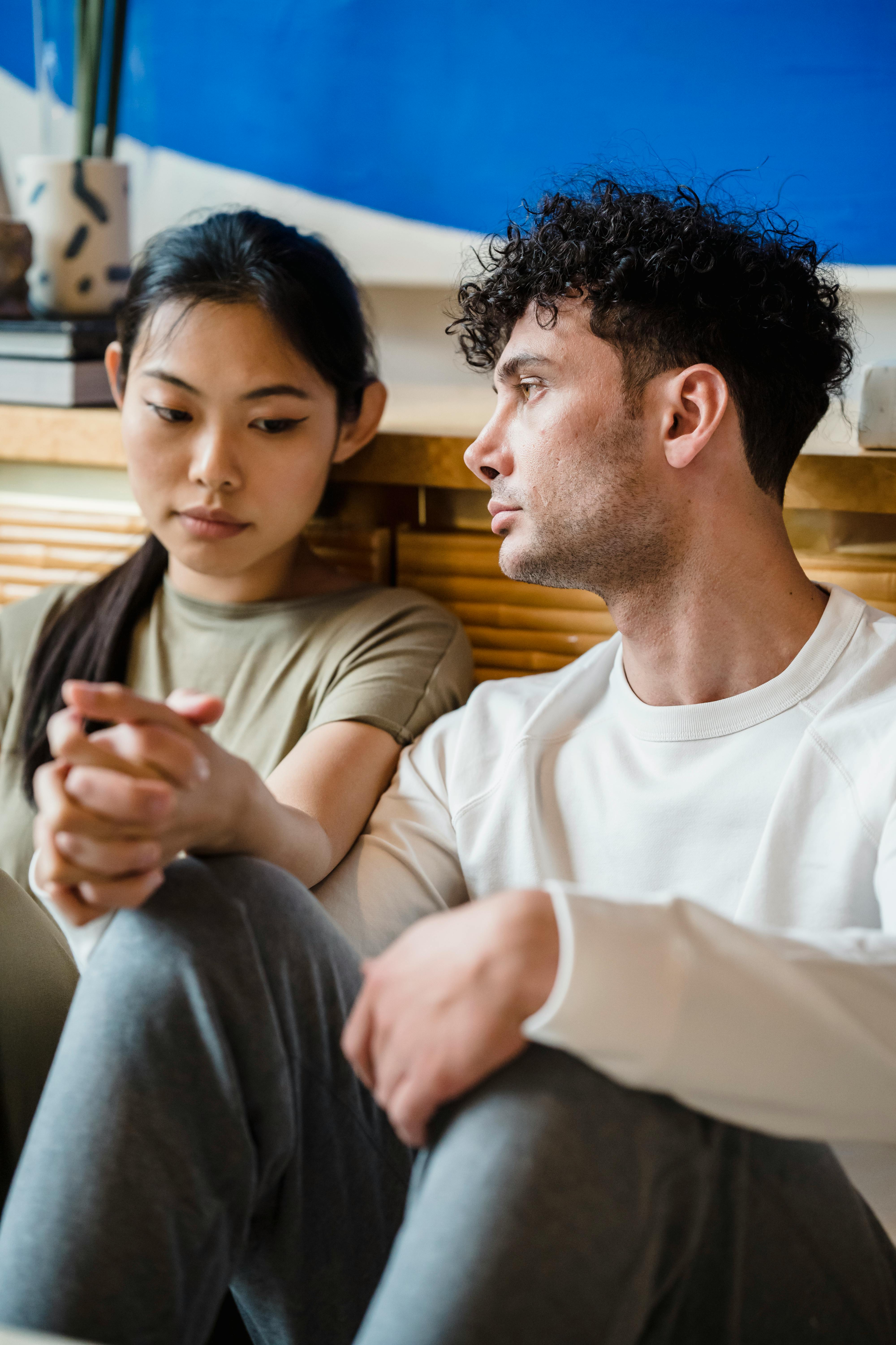 Man in Pink Polo Shirt Sitting Beside a Woman in White T-Shirt