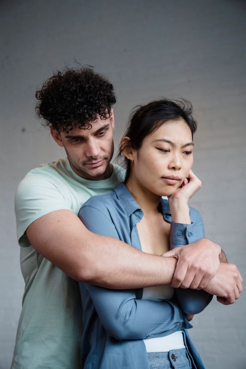 Free A young interracial couple in an emotional embrace, conveying support and affection. Stock Photo