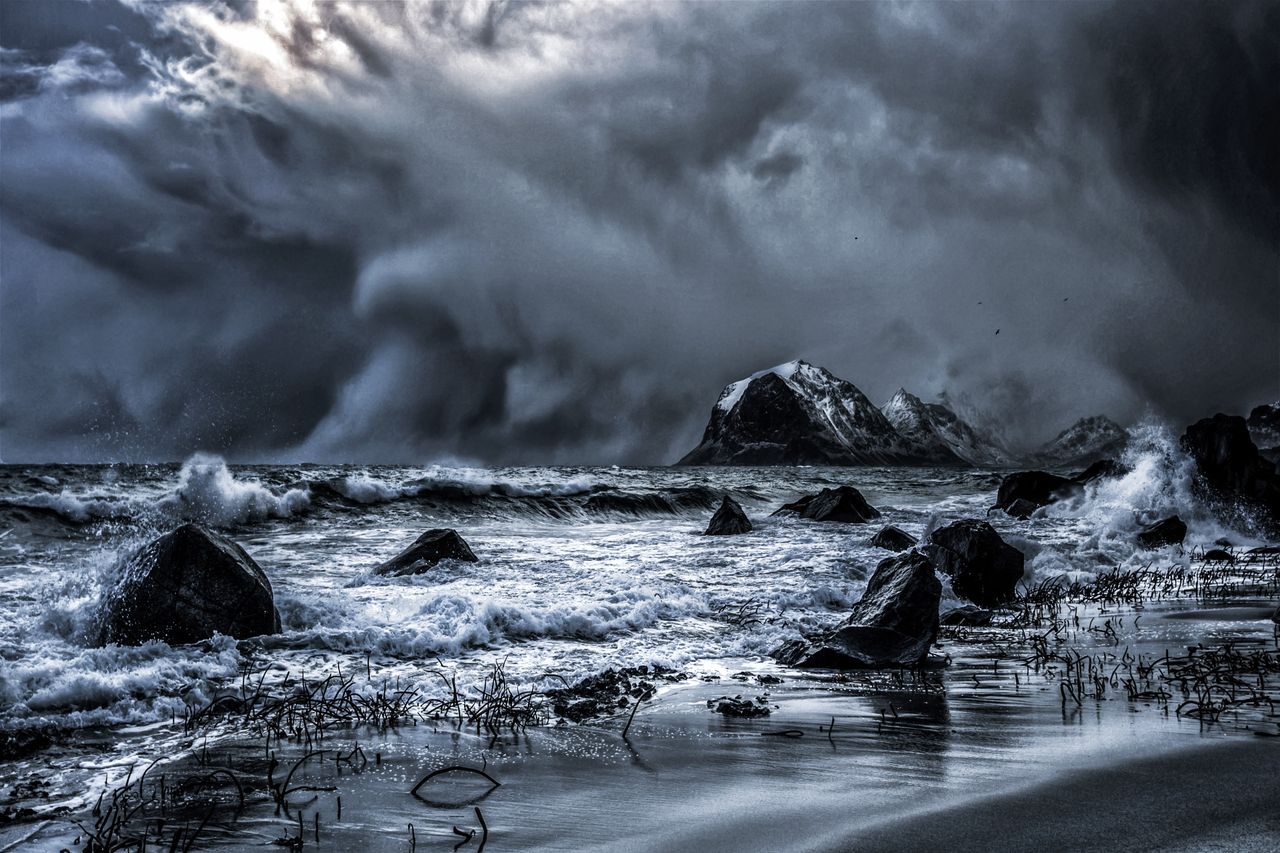 powerful waves crash on nordland norway shore under dramatic storm clo
