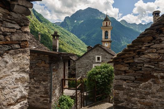 Picturesque view of Sonogno village with mountain backdrop and historic architecture.