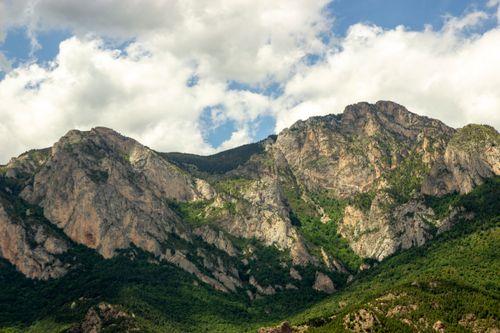 Free Lush green Spanish mountain range under a partly cloudy sky, ideal for nature lovers. Stock Photo
