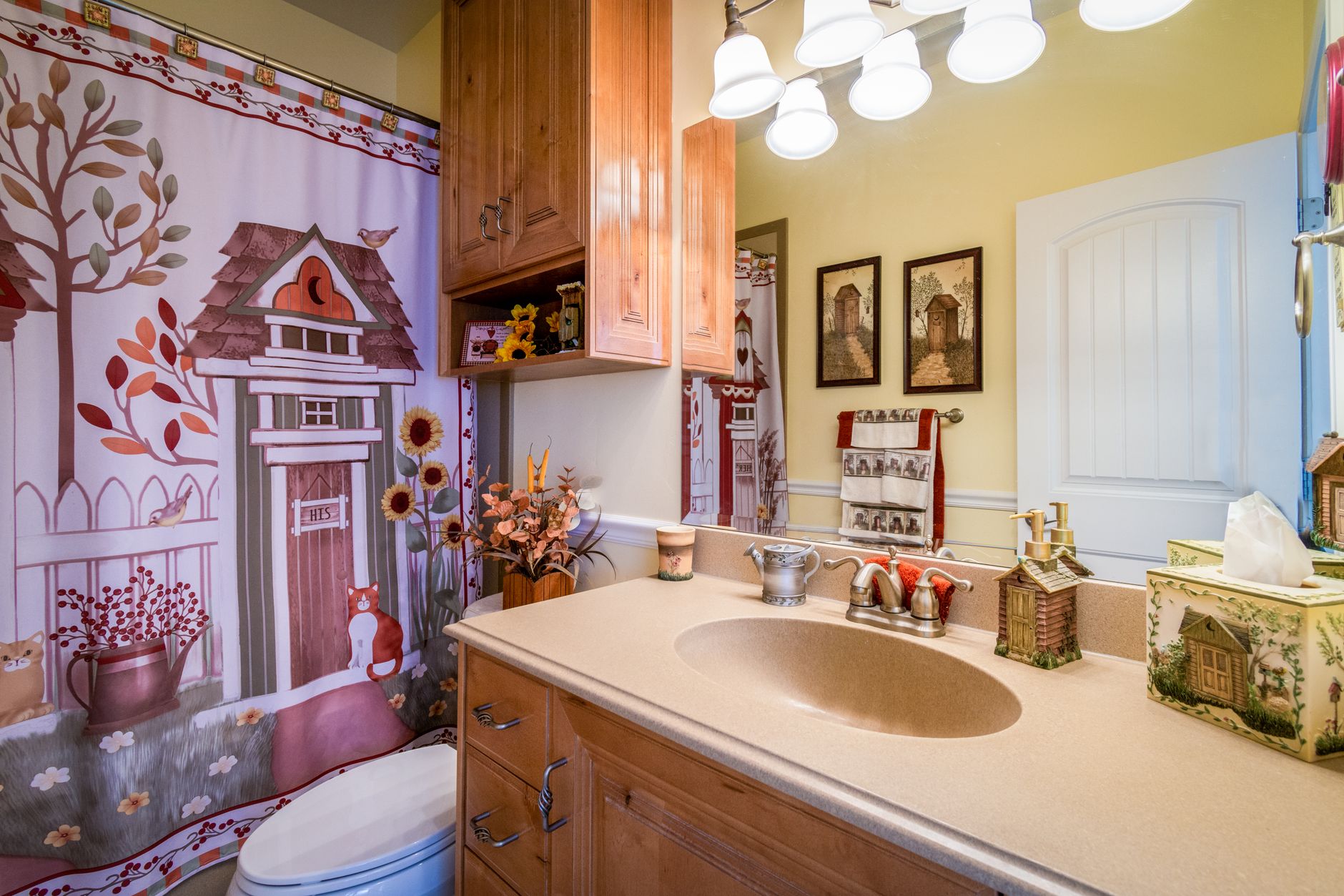 farmhouse bathroom setup on a budget Warm and inviting bathroom with rustic decor and countryside-inspired artwork on shower curtain.
