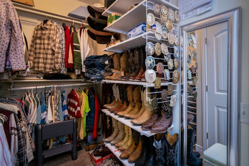 Free Assorted Clothes and Boots Inside a Closet Room Stock Photo