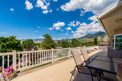 Free Expansive terrace with seating overlooking majestic mountains under a clear blue sky. Stock Photo