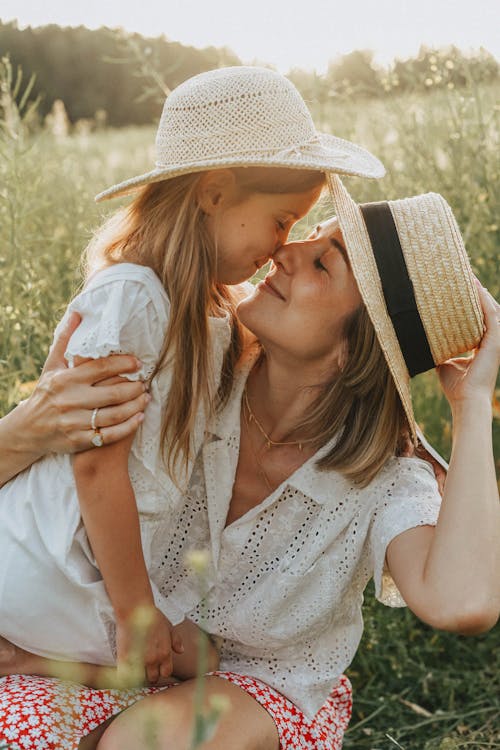 A Mother and Daughter Wearing Straw Hats