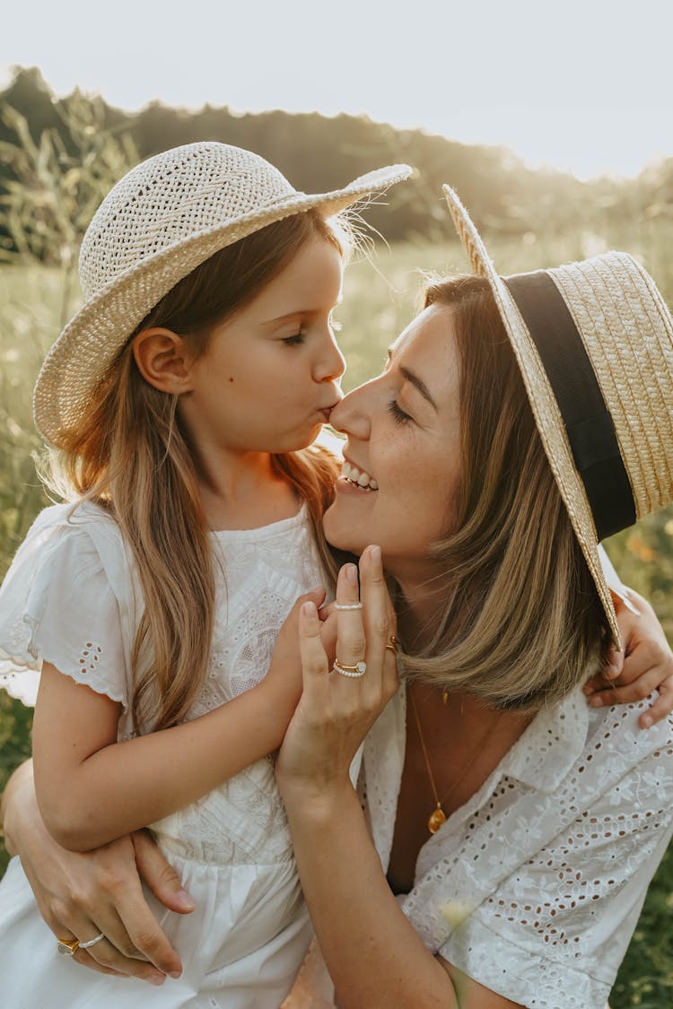 Mother And Daughter Embracing In A Summer Meadow