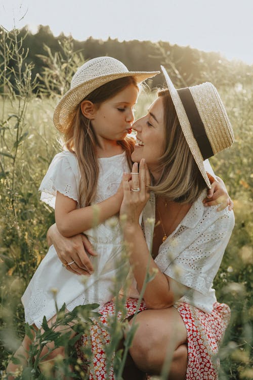 Free Mother and Daughter Playing in a Summer Meadow Stock Photo