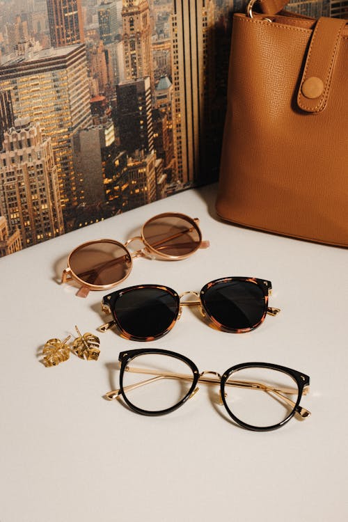 Sunglasses Near the Brown Leather Bag 