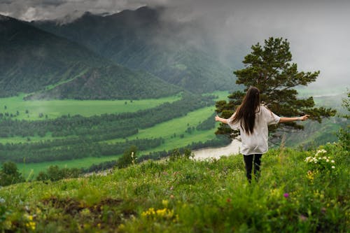 Woman in Grassy Mountain Valley 