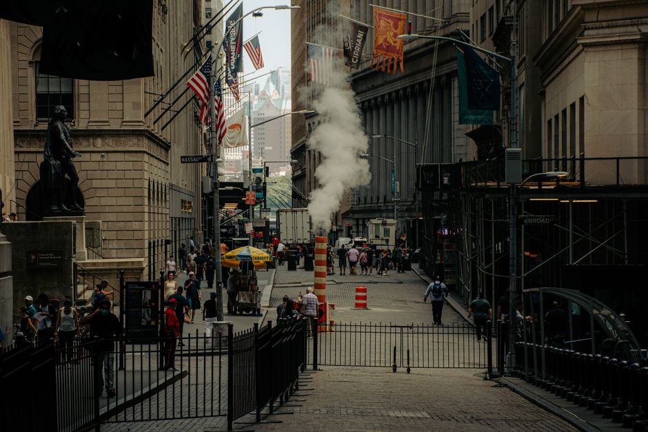 Busy New York street scene featuring people, smoke vent, and iconic architecture.