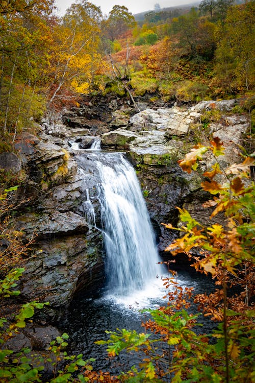 Cascading Waterfall on Brown Rocky Ledge