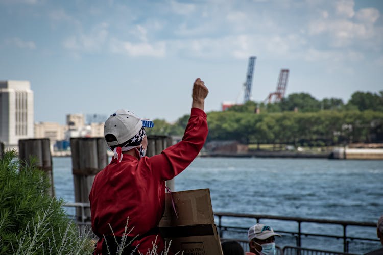 Person In Red Long Sleeve Shirt With Clenched Fist