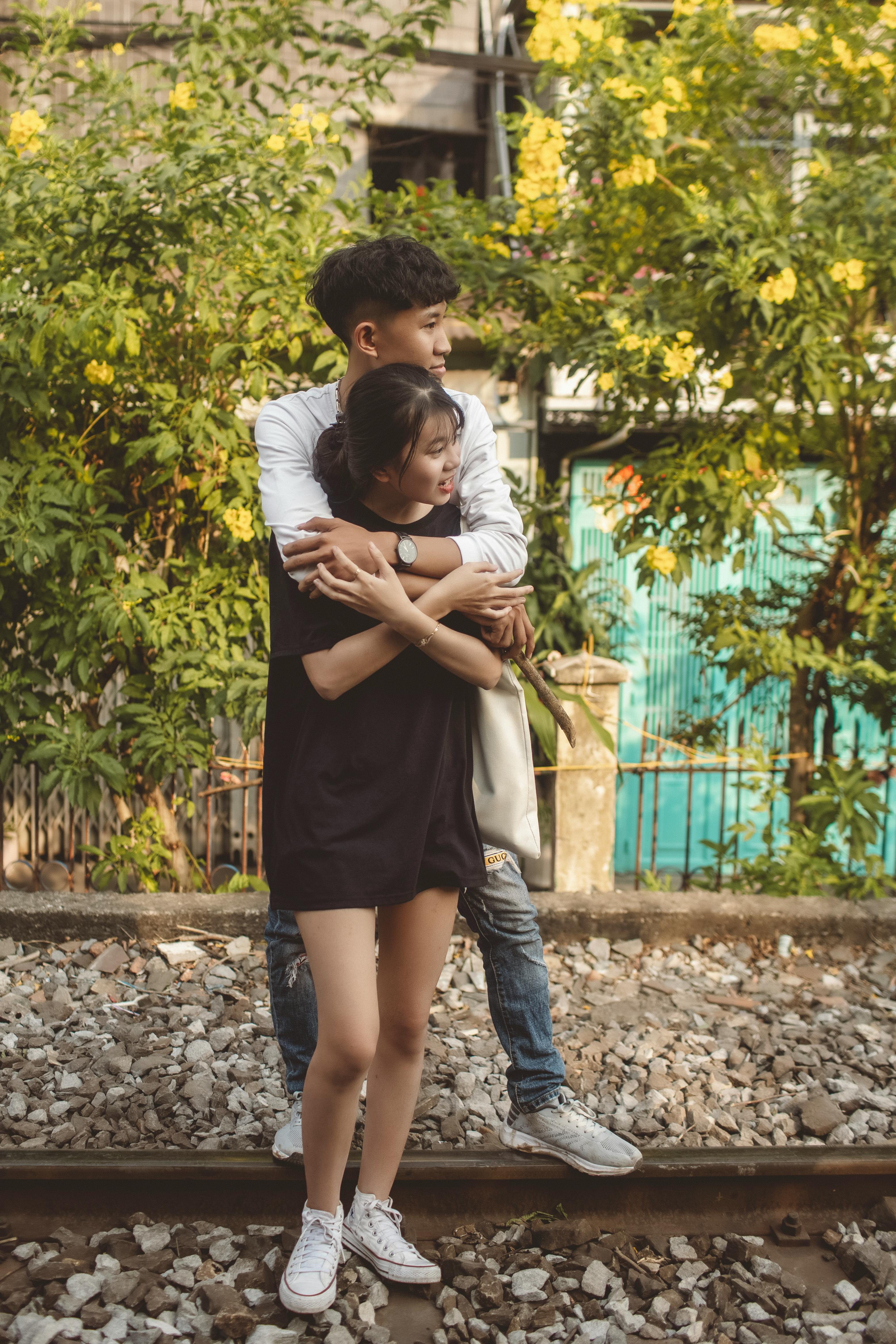 young man hugging girl from behind