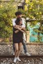Young Man Hugging Girl from Behind