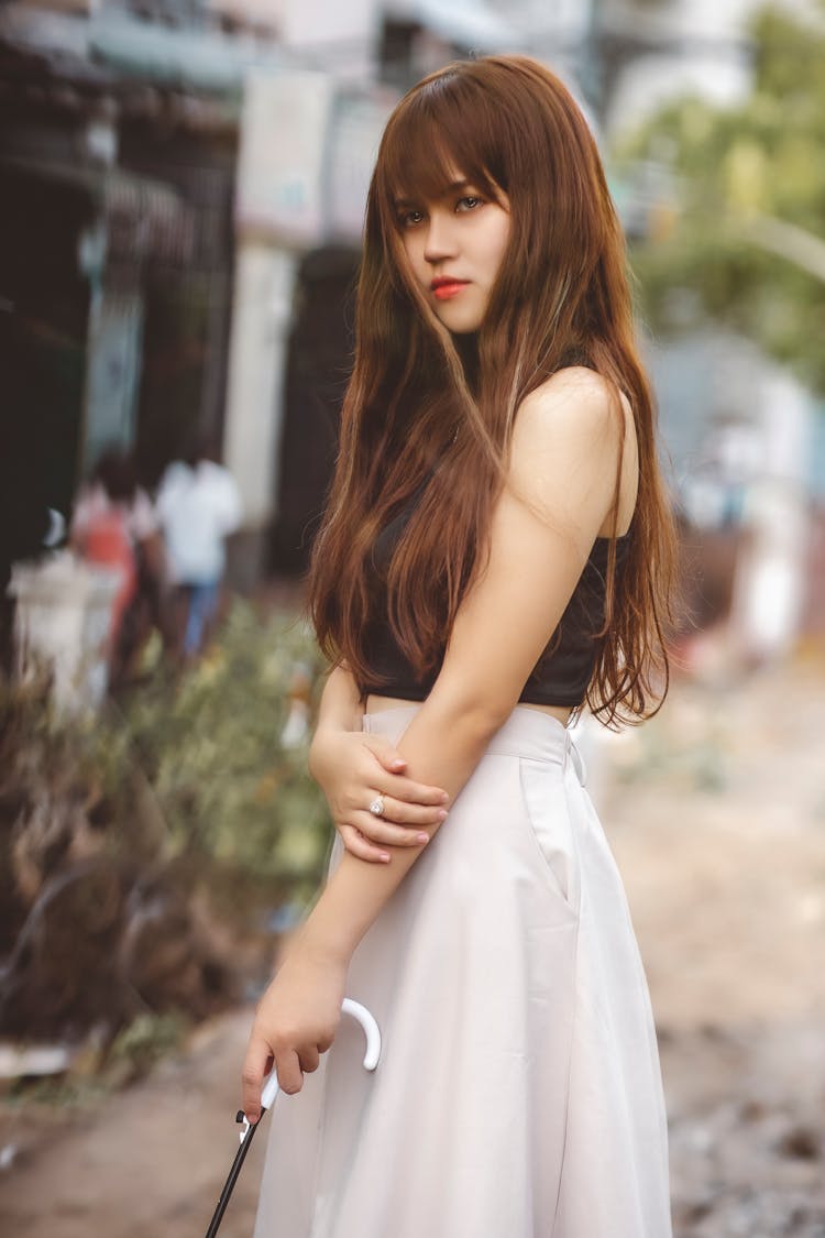 Girl In Black Crop Top And White Skirt Holding Umbrella Handle