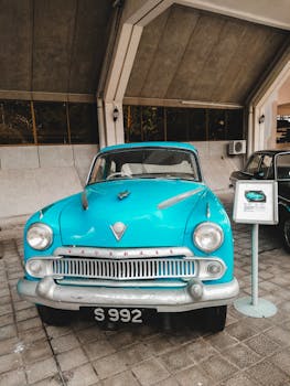 Classic Vauxhall car in a Malaysian museum, showcasing retro automotive design.