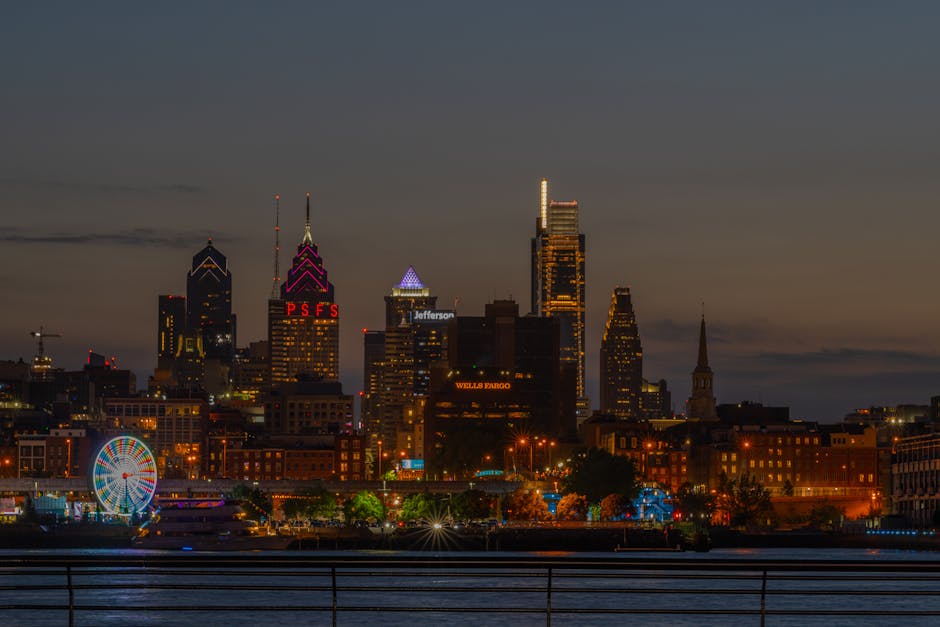 Stunning view of Philadelphia skyline illuminated at night with a Ferris wheel.