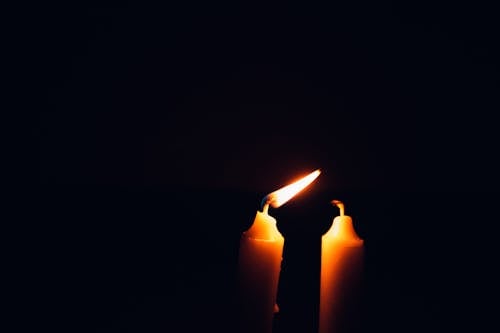 Burning Candle on Dark Background