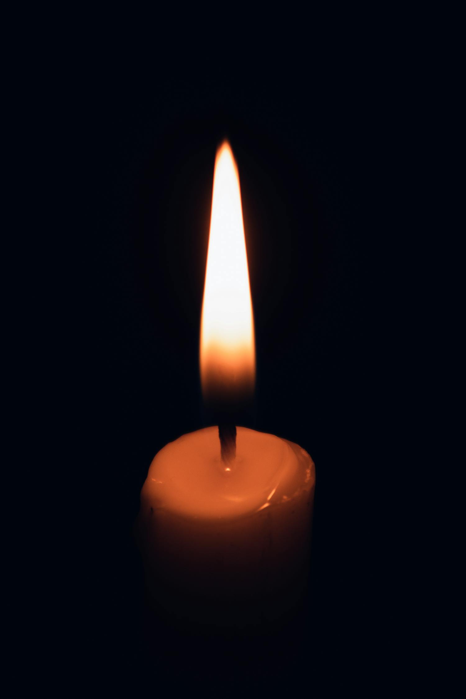 Lighted Candle in Dark Room · Free Stock Photo