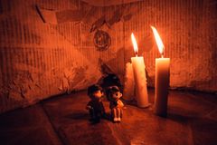 A warm candlelit setting featuring small figurines in a cozy still life arrangement.