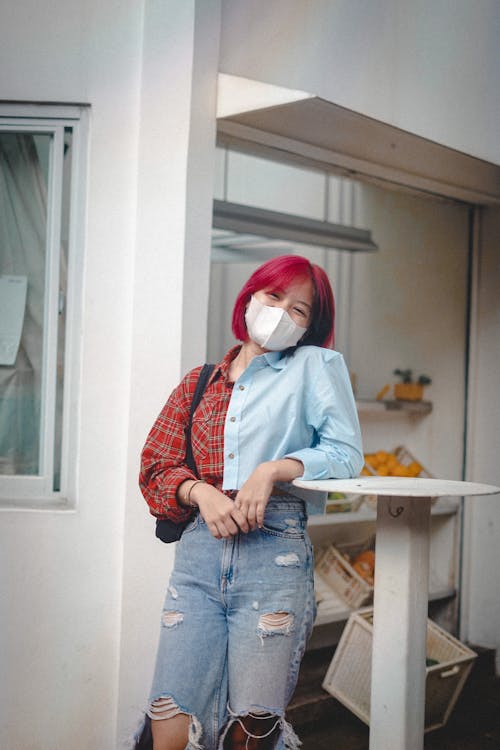 Woman Wearing Facemask Leaning on the Table