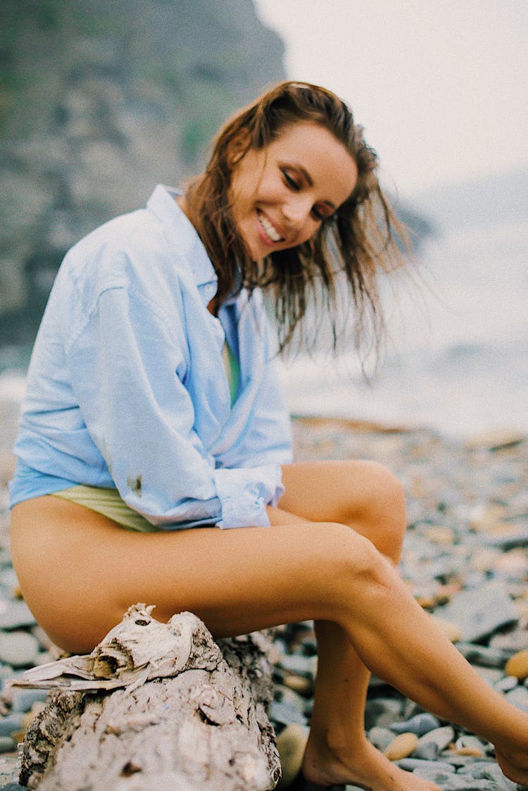 Woman In Blue Long Sleeve Shirt Sitting On Brown Log