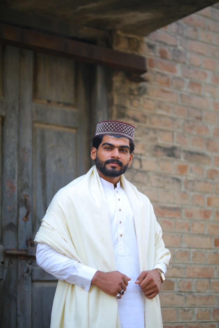 Man In White Traditional Clothing With Topi