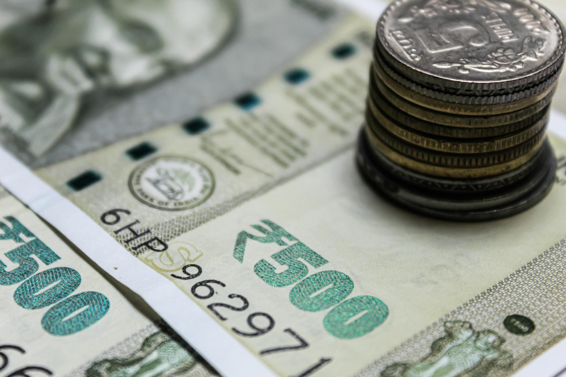 Detailed view of Indian rupees and stacked coins, representing currency and finance.