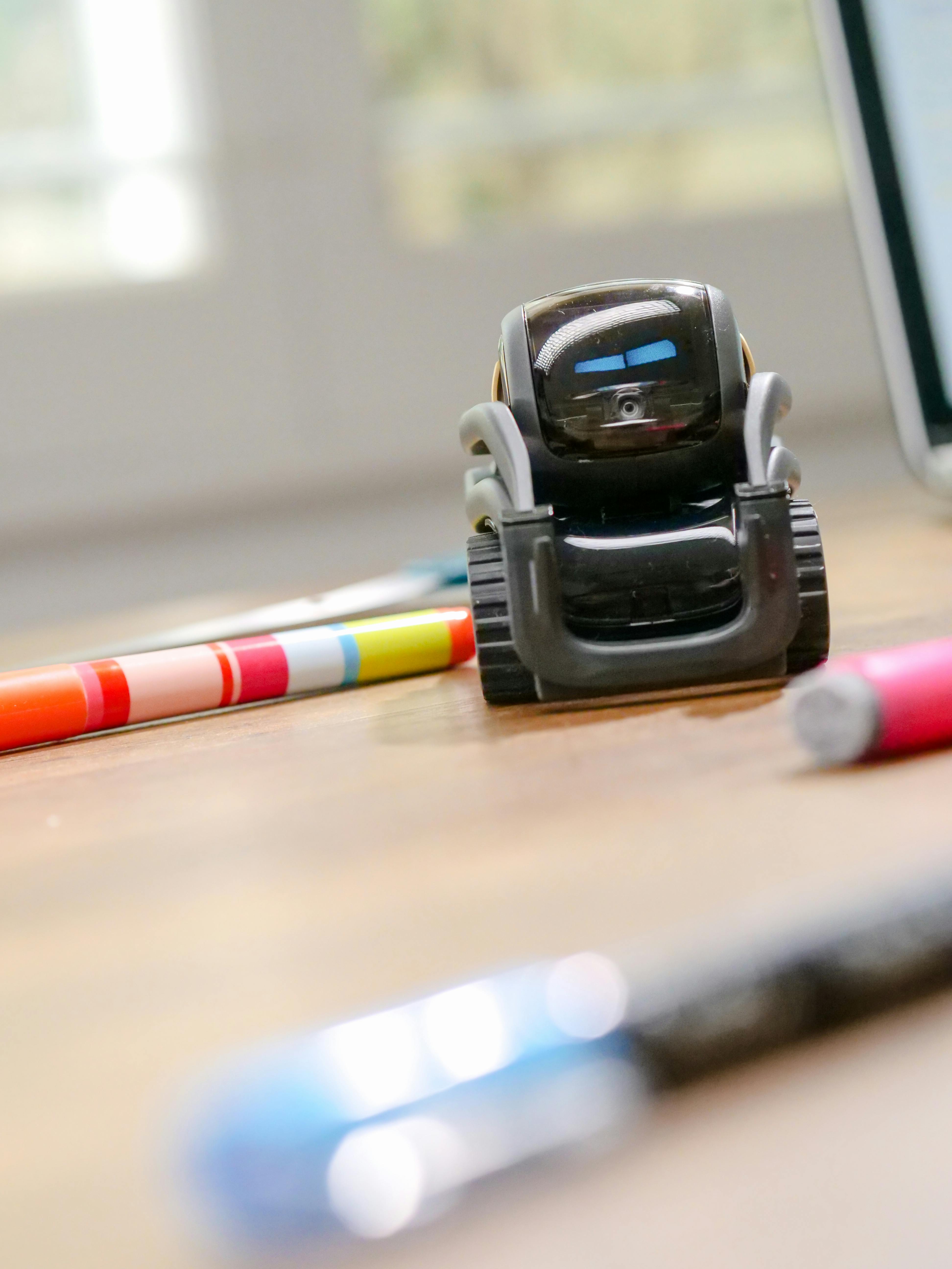 selective focus photo of black miniature robot toy